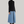 Load image into Gallery viewer, woman standing with black short hair. wearing a black fitted long-sleeve turtleneck and long blue denim skirt and maroon high heel boots
