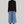 Load image into Gallery viewer, woman standing with short black hair, wearing a fitted black long-sleeve turtleneck and long midi blue denim skirt. styled with maroon boots and gold necklace
